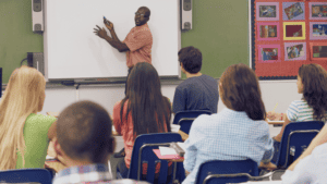 instructor teaching on an interactive whiteboard in a classroom
