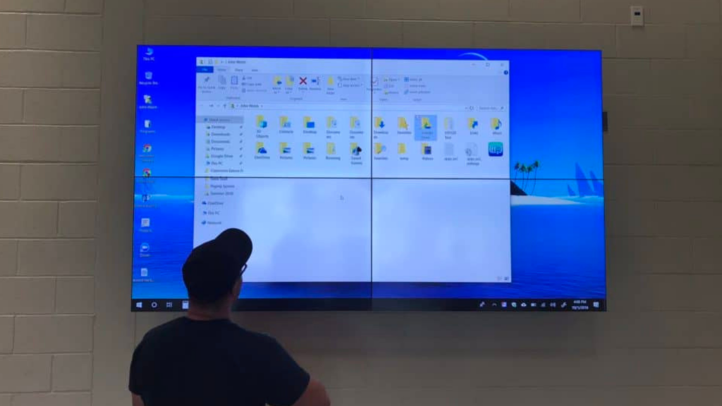 Man displaying computer screen on a video wall