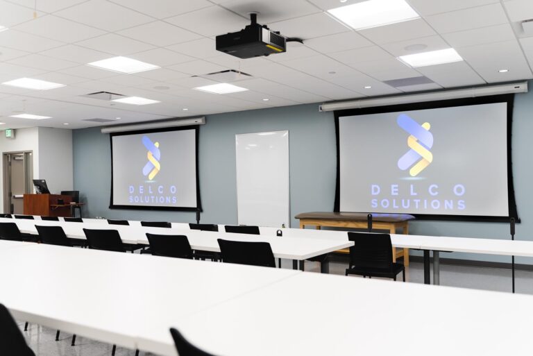 Classroom with two large projector screens at the front