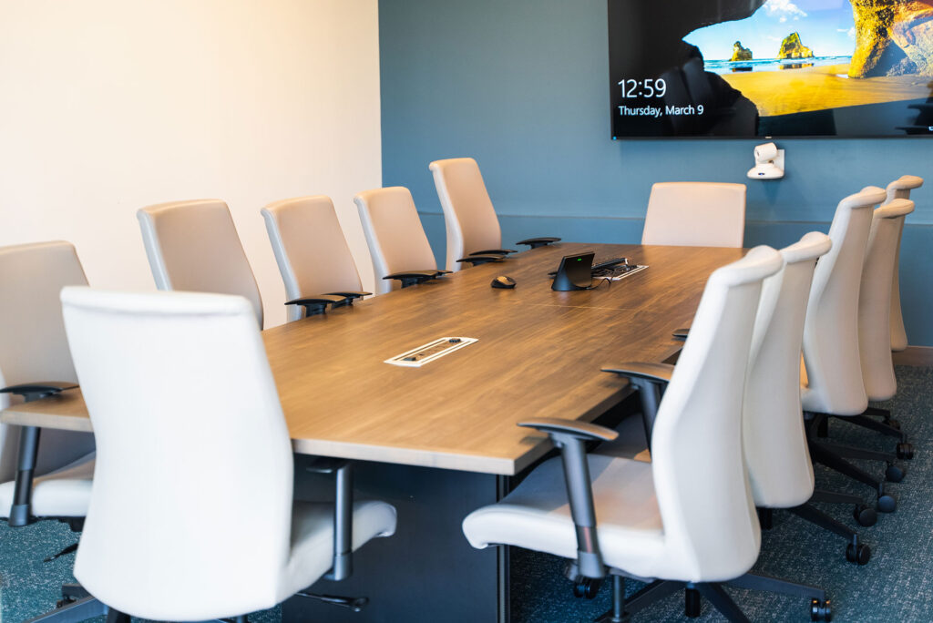 Conference room table with a video conferencing system at the end