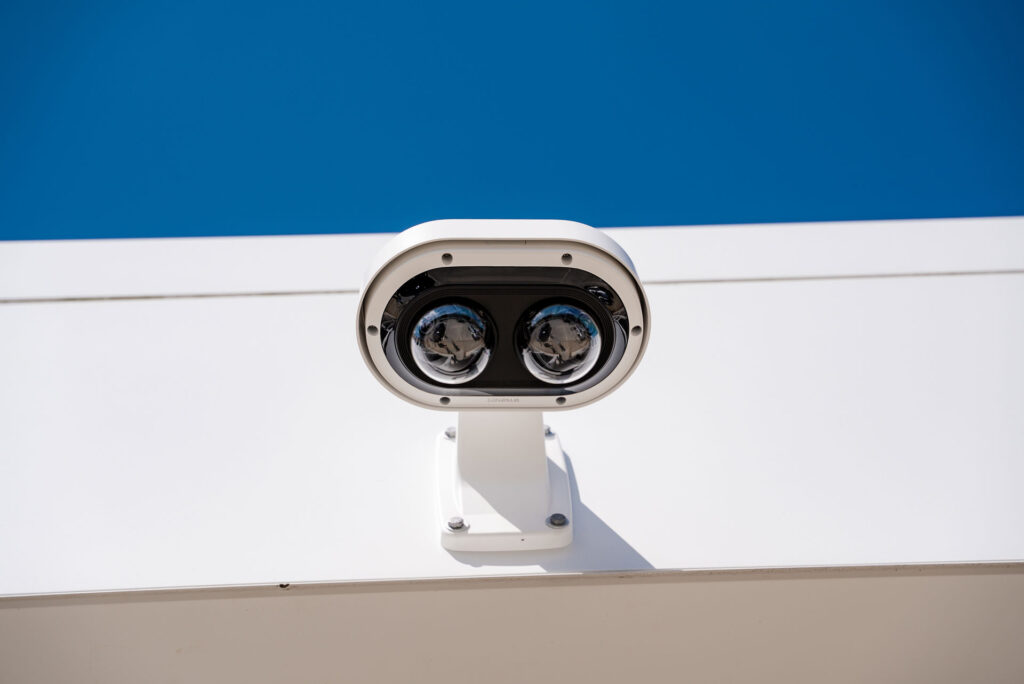 Closeup of a security camera mounted to a business exterior