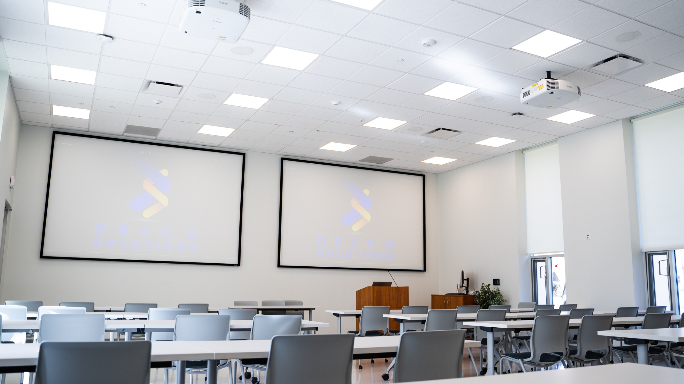 Classroom setup for hybrid learning with projectors and screens