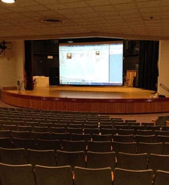 auditorium with large screen and projector